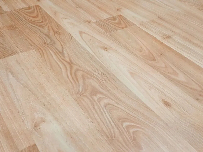 Smooth light brown luxury vinyl plank flooring with natural wood-look texture